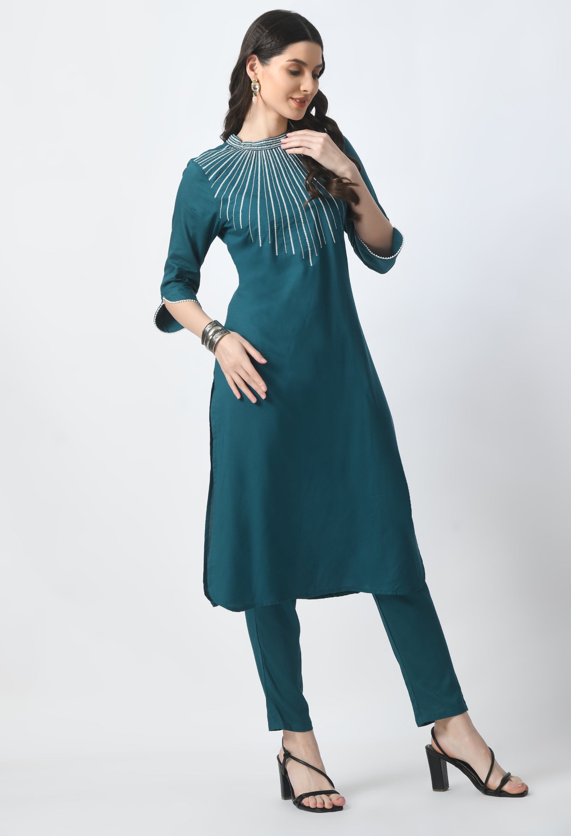 “Bottle green embroidered rayon kurta pant set with a printed dupatta. The kurta features intricate embroidery, paired with matching pants and a vibrant dupatta with distinctive patterns, combining traditional elegance with modern style.”