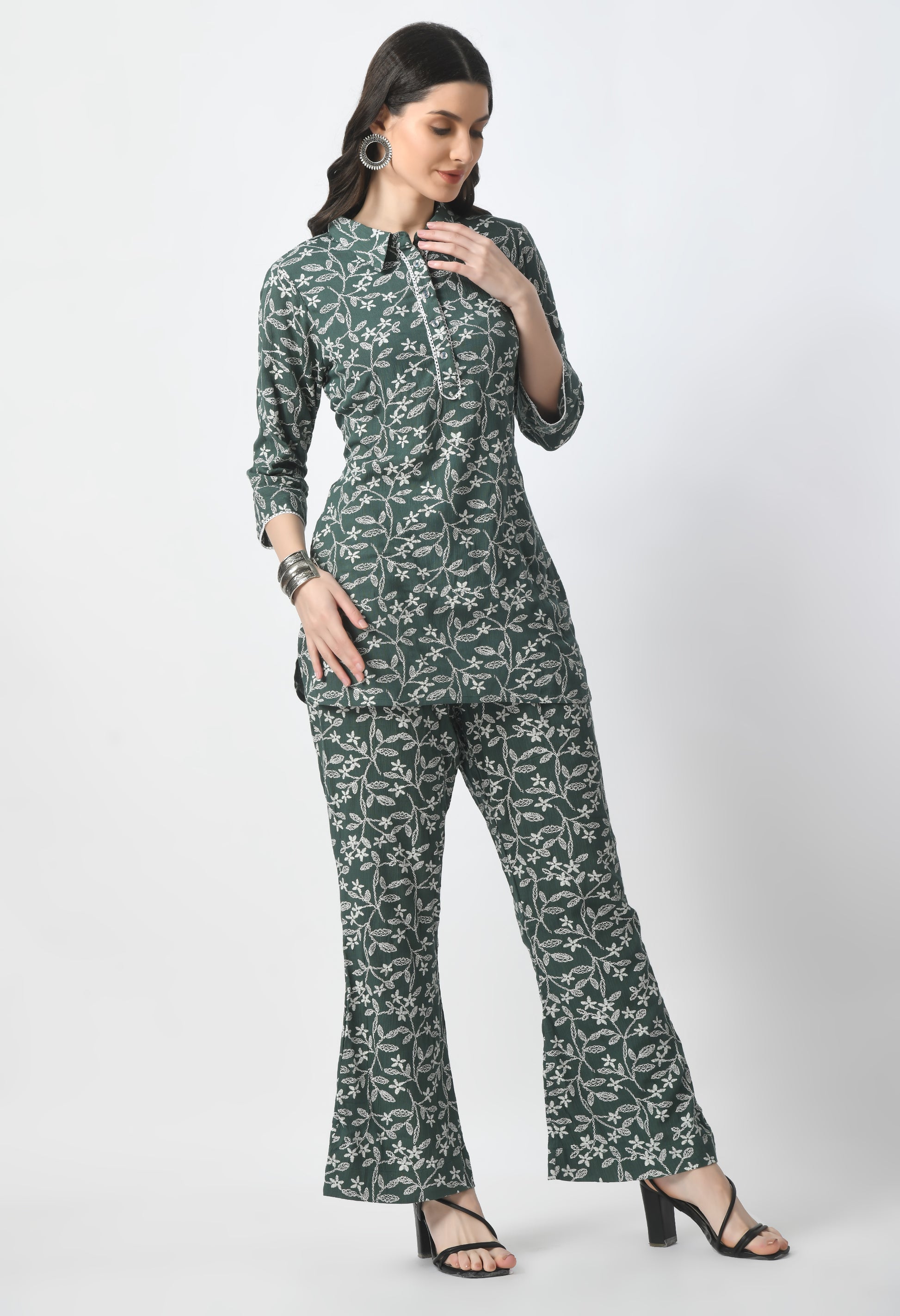 "Rayon Crape Co-Ord Set with a matching printed top and high-waisted trousers. The top has a relaxed fit and flutter sleeves, while the trousers have a wide-leg style. Made from lightweight and breathable fabric."