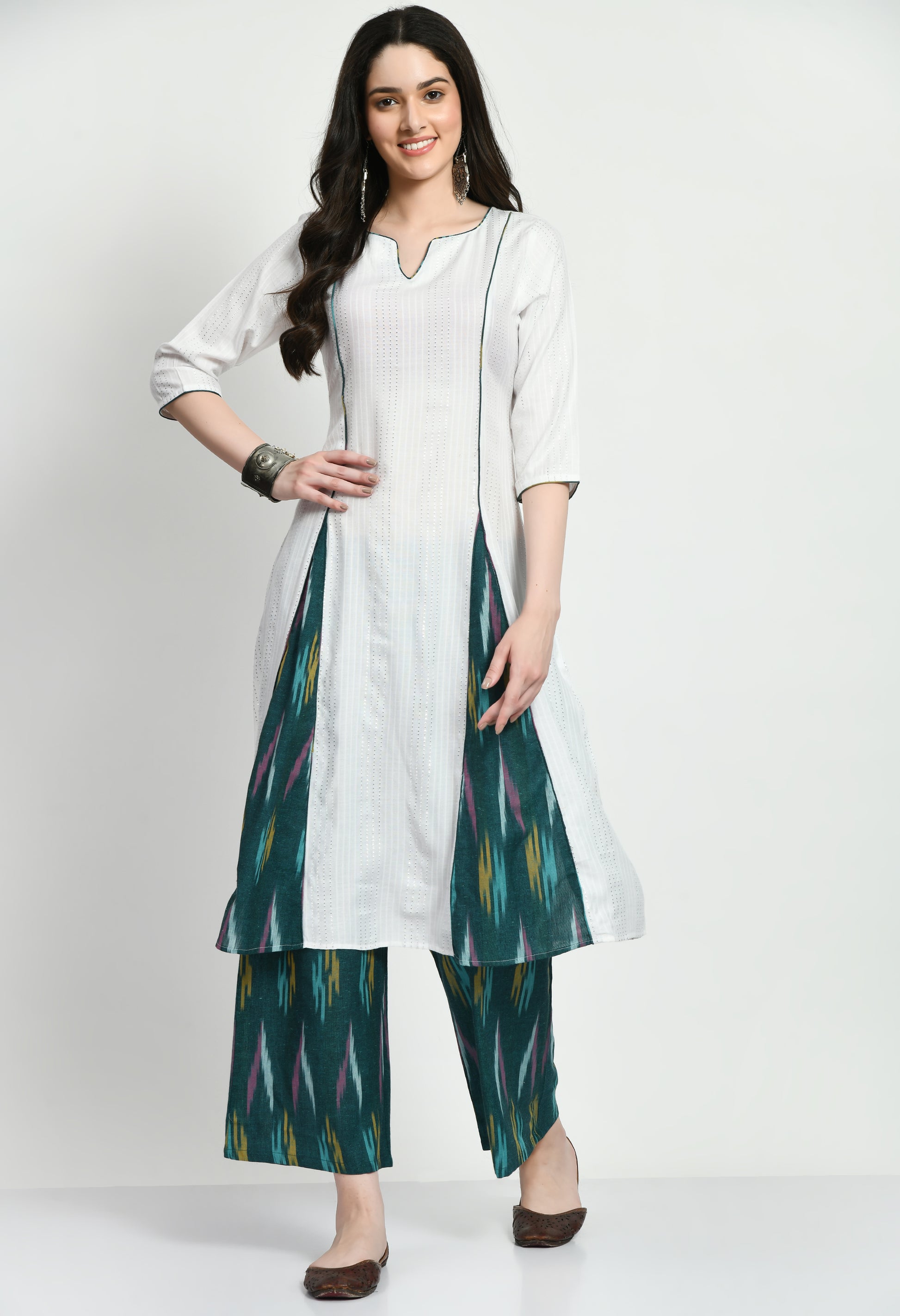 An exquisite Anarkali Kurta set with a flowing, finely designed Kurta, Ikkat-patterned pants, and a gorgeously embroidered dupatta. Perfect for celebrations and unique gatherings, this ensemble blends classic elegance with contemporary refinement.