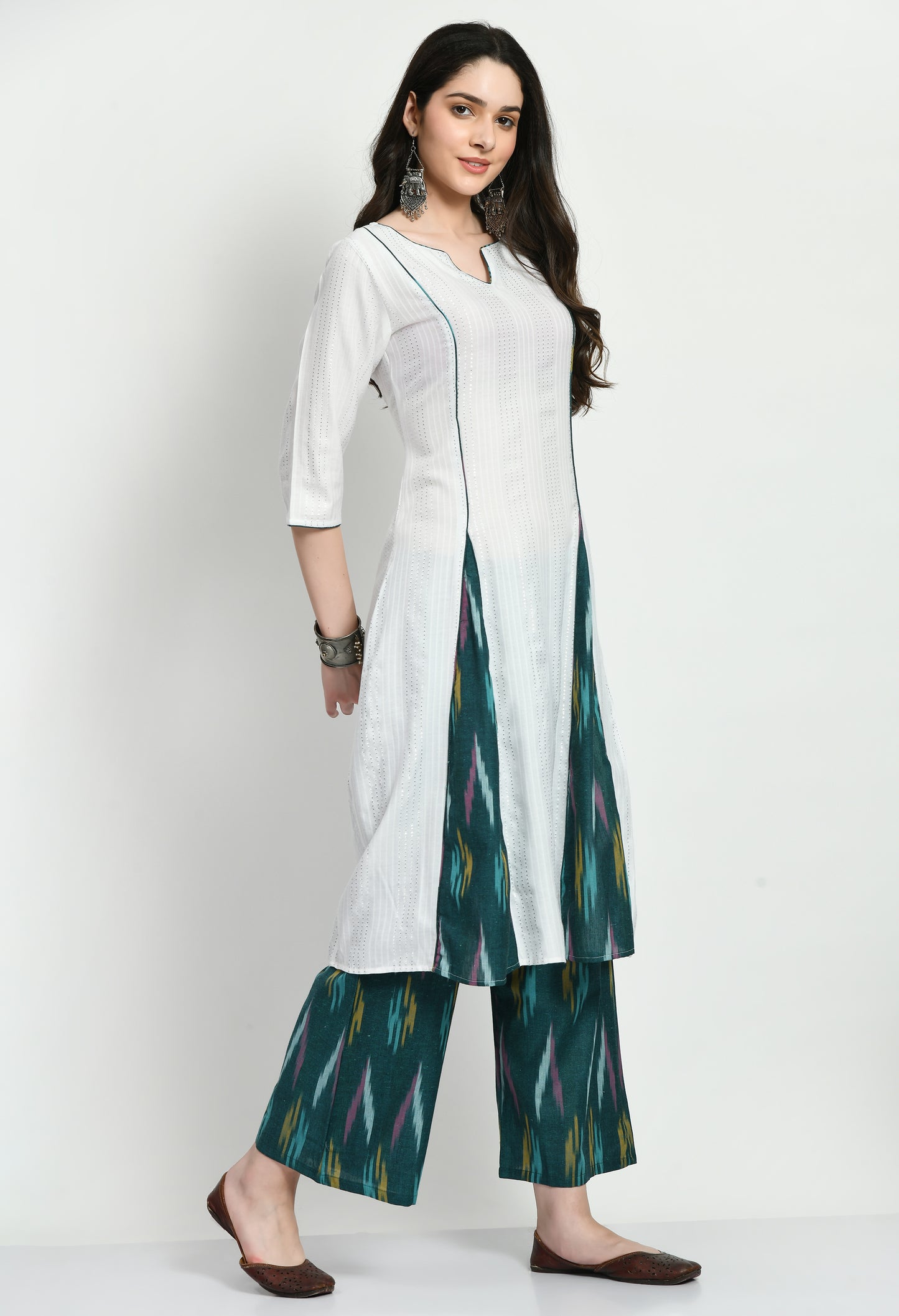 An exquisite Anarkali Kurta set with a flowing, finely designed Kurta, Ikkat-patterned pants, and a gorgeously embroidered dupatta. Perfect for celebrations and unique gatherings, this ensemble blends classic elegance with contemporary refinement.