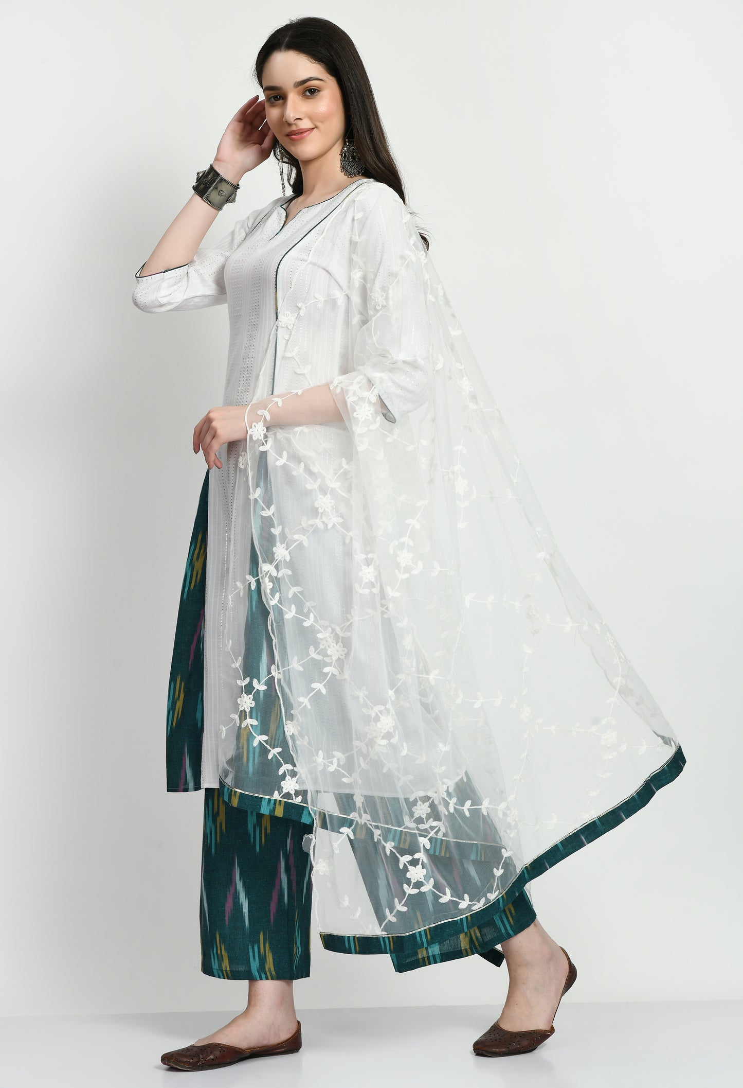 An exquisite Anarkali Kurta set with a flowing, finely designed Kurta, Ikkat-patterned pants, and a gorgeously embroidered dupatta. Perfect for celebrations and unique gatherings, this ensemble blends classic elegance with contemporary refinement.