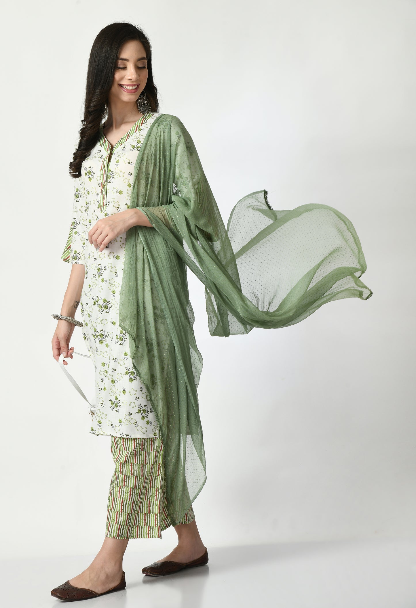 "Elegant women's ethnic ensemble featuring a printed kurta, palazzo pants, and a matching dupatta. The set showcases intricate patterns and a stylish design, ideal for festive or casual occasions."