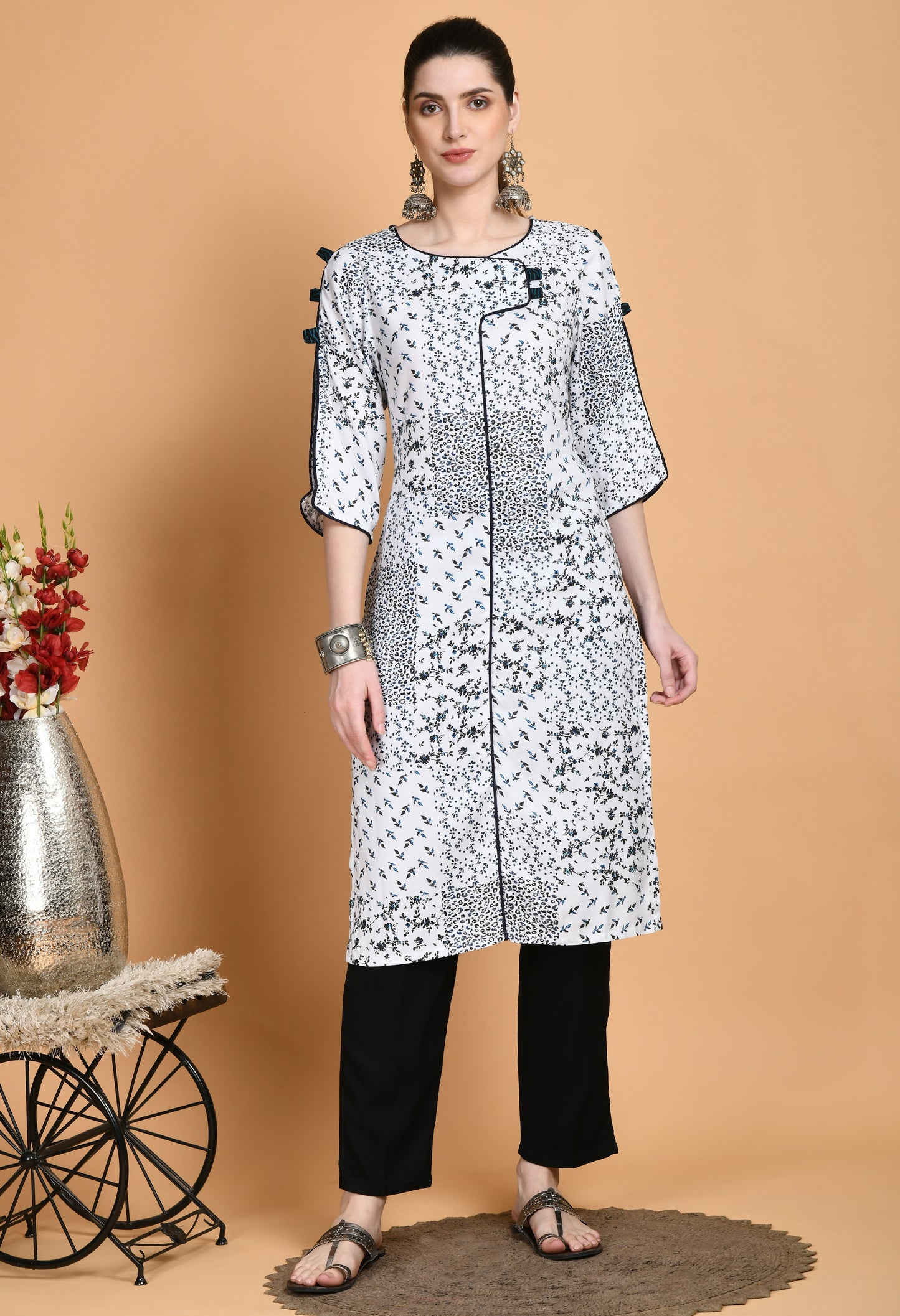 "White Printed Kurta with elegant patterns and stylish sleeves. The kurta features a classic neckline, unique sleeve details such as ruffles or bell shapes, and a comfortable, flowing fit."