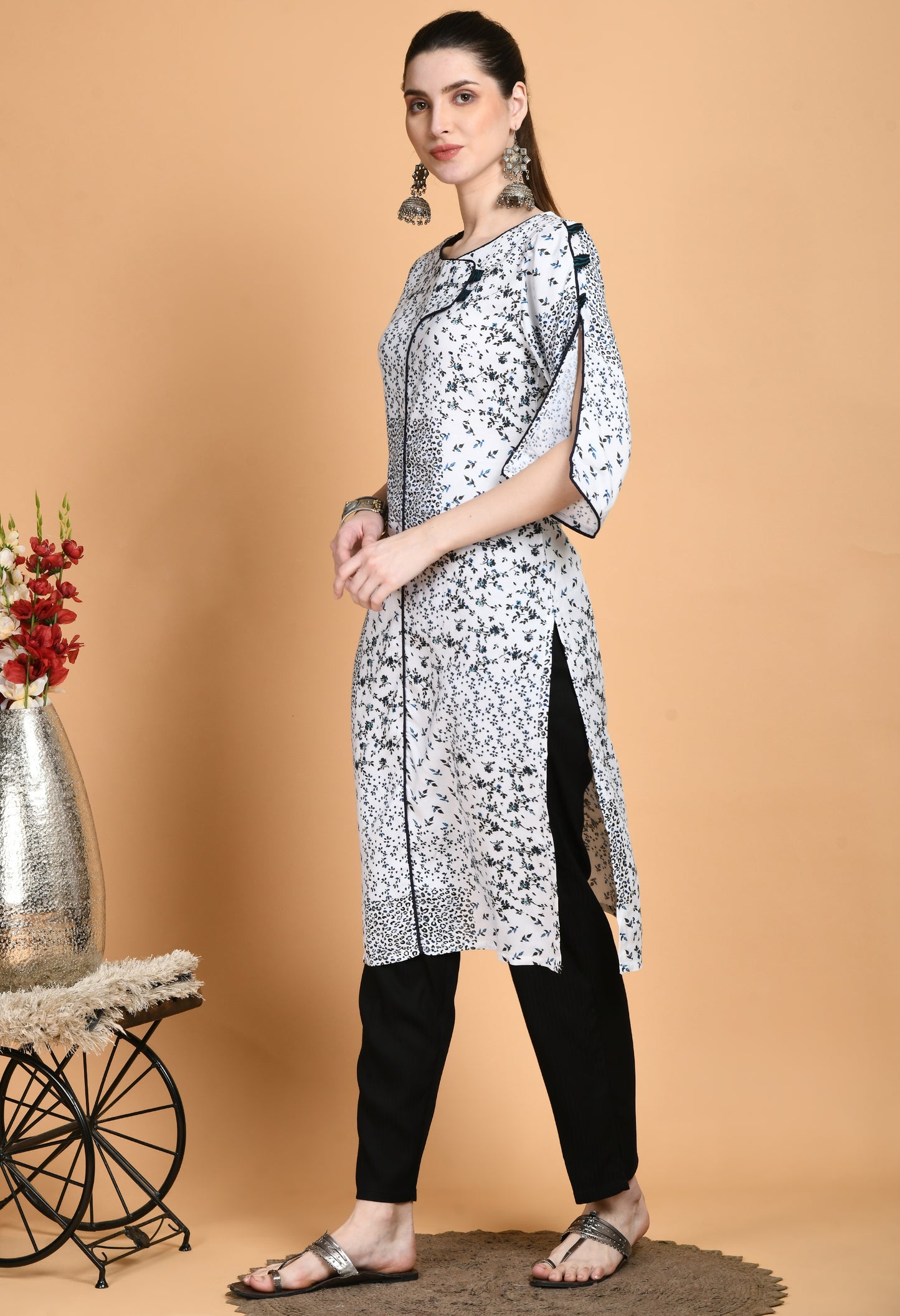 "White Printed Kurta with elegant patterns and stylish sleeves. The kurta features a classic neckline, unique sleeve details such as ruffles or bell shapes, and a comfortable, flowing fit."