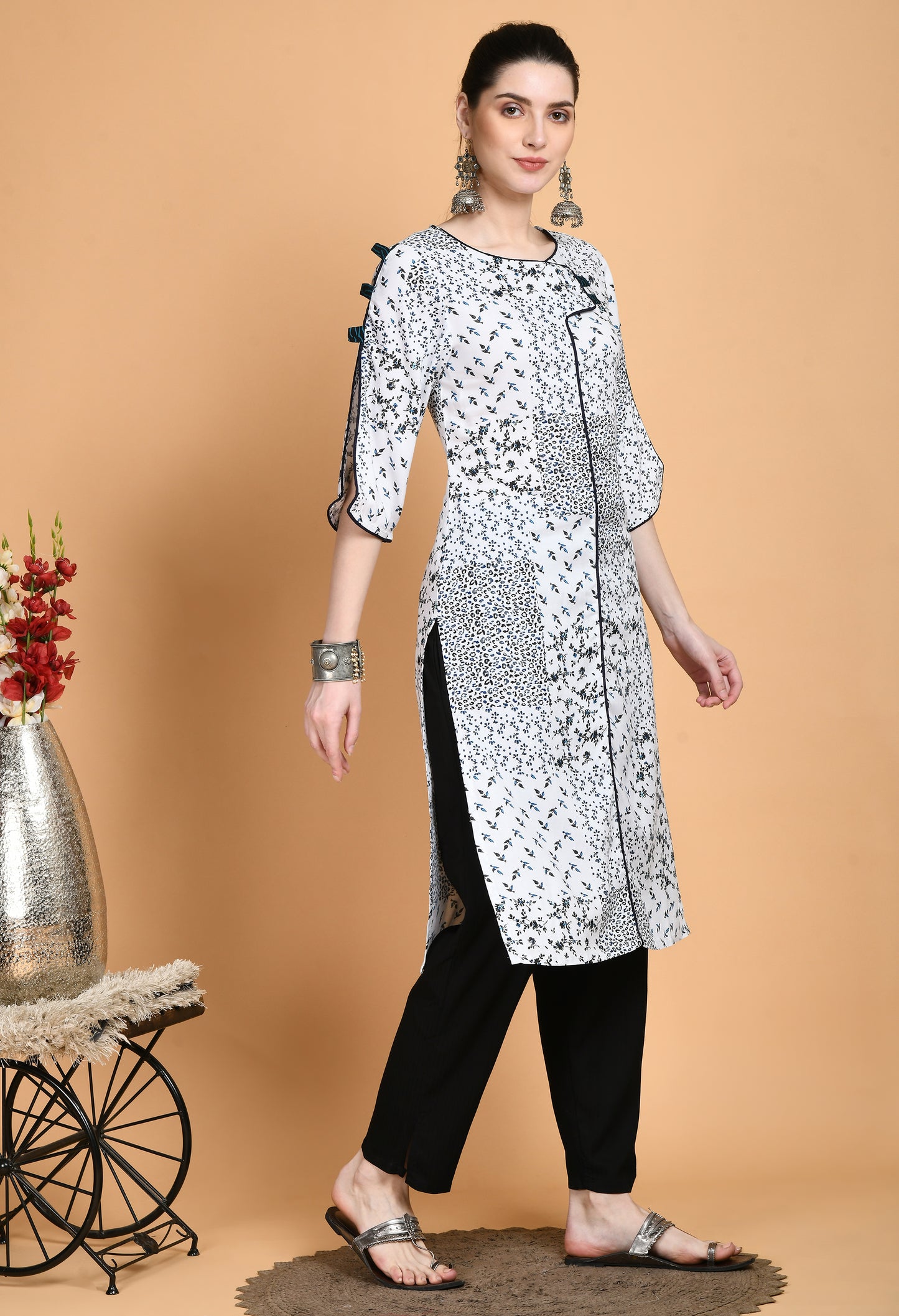 "White Printed Kurta with elegant patterns and stylish sleeves. The kurta features a classic neckline, unique sleeve details such as ruffles or bell shapes, and a comfortable, flowing fit."