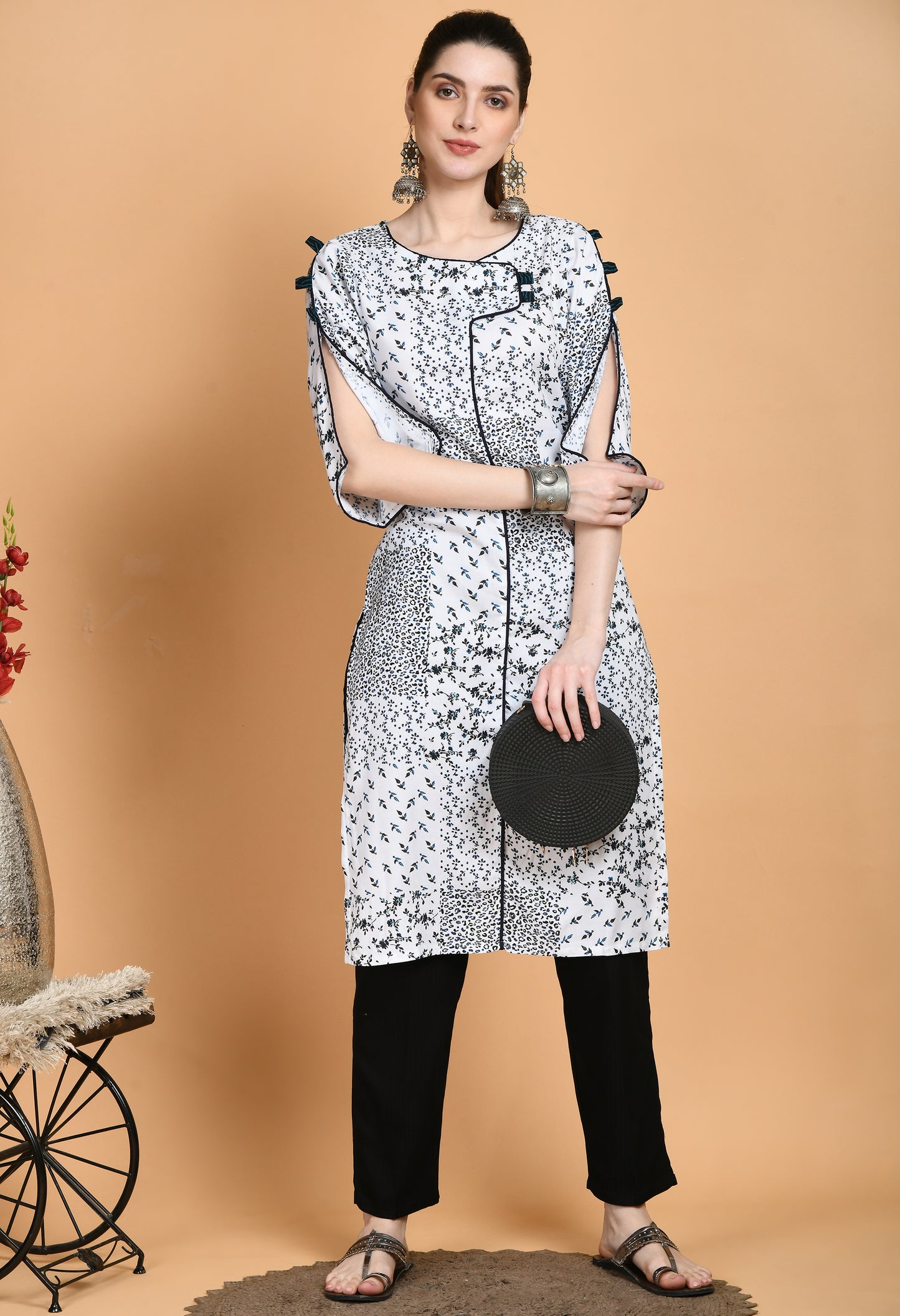 "White Printed Kurta with elegant patterns and stylish sleeves. The kurta features a classic neckline, unique sleeve details such as ruffles or bell shapes, and a comfortable, flowing fit."